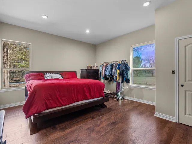a bed sitting in a bedroom next to a window