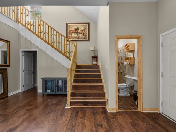a view of entryway and hall with wooden floor