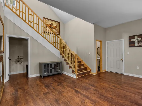 a view of entryway and hall with wooden floor