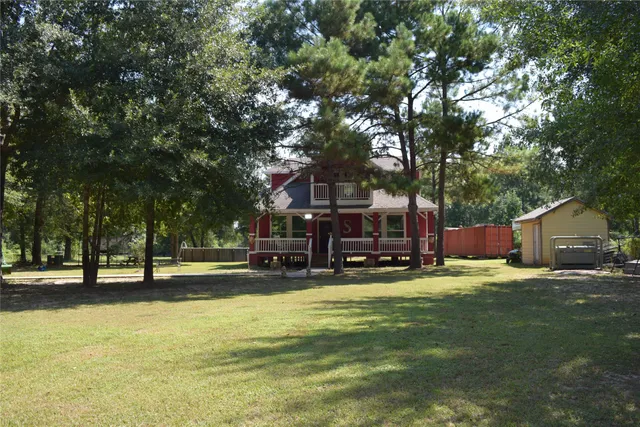 a view of a house with pool and sitting area