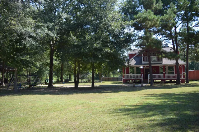 a view of swimming pool with outdoor seating and a garden
