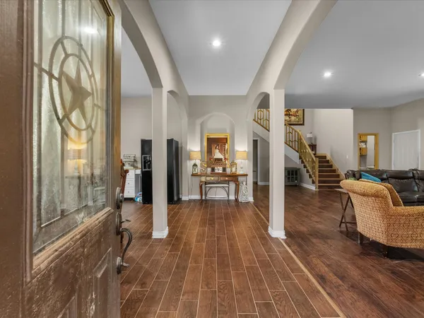 a living room with furniture and a wooden floor