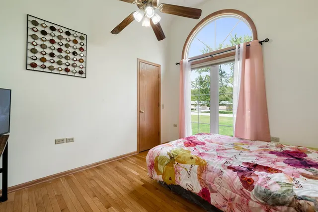 a bedroom with a bed and a large window