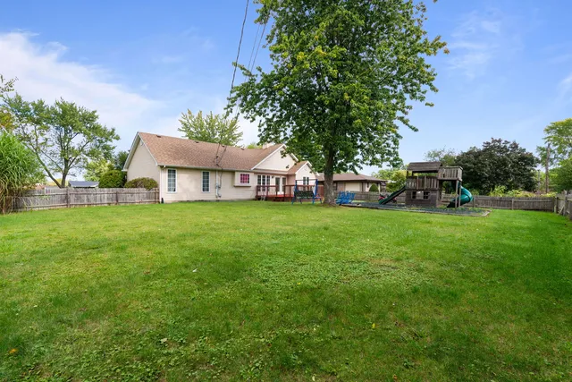 a view of house that has a yard