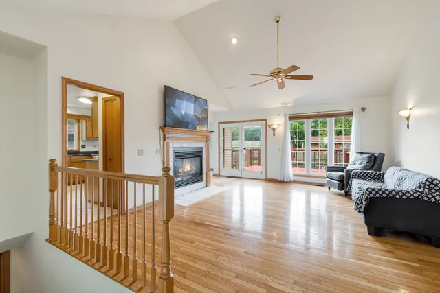 a living room with furniture a fireplace and a chandelier