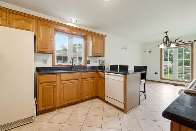a large white kitchen with a large window