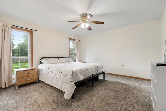 a bed sitting in a room next to a window