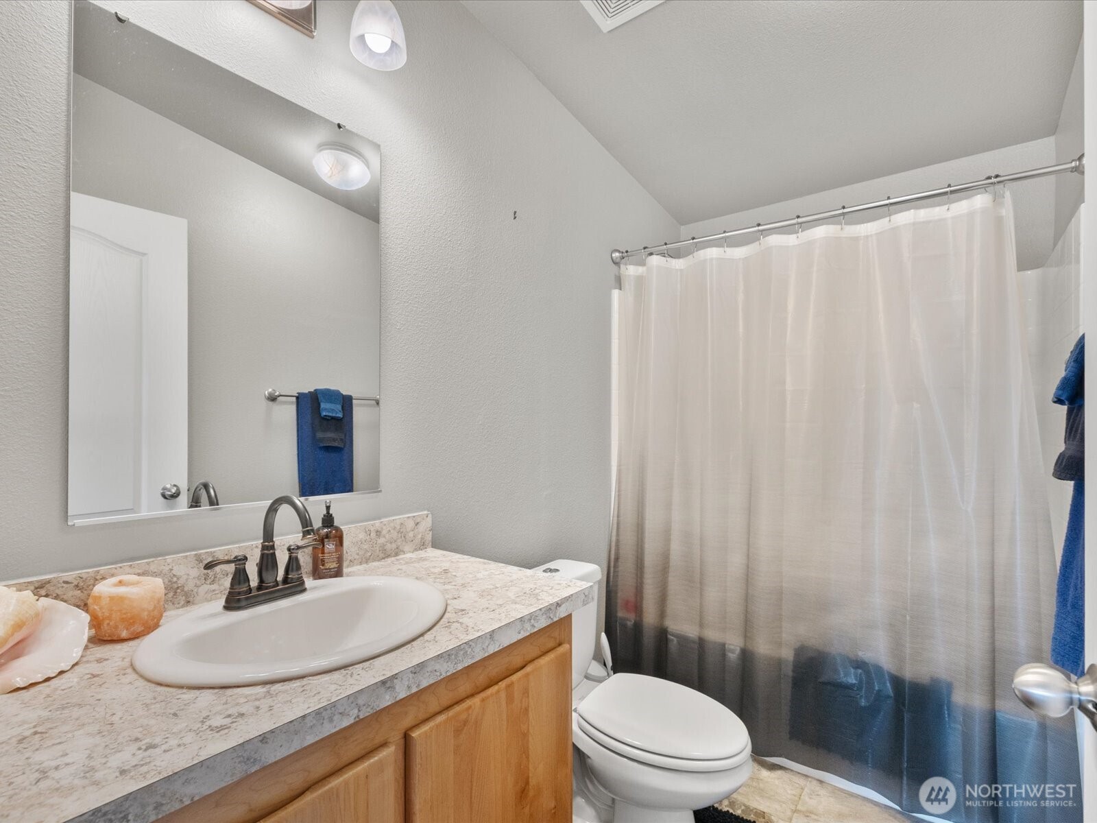 12721 West Macs Loop Road Granite Falls, WA 98252 - Photo 17 of 31 a bathroom with a granite countertop sink a toilet and a mirror