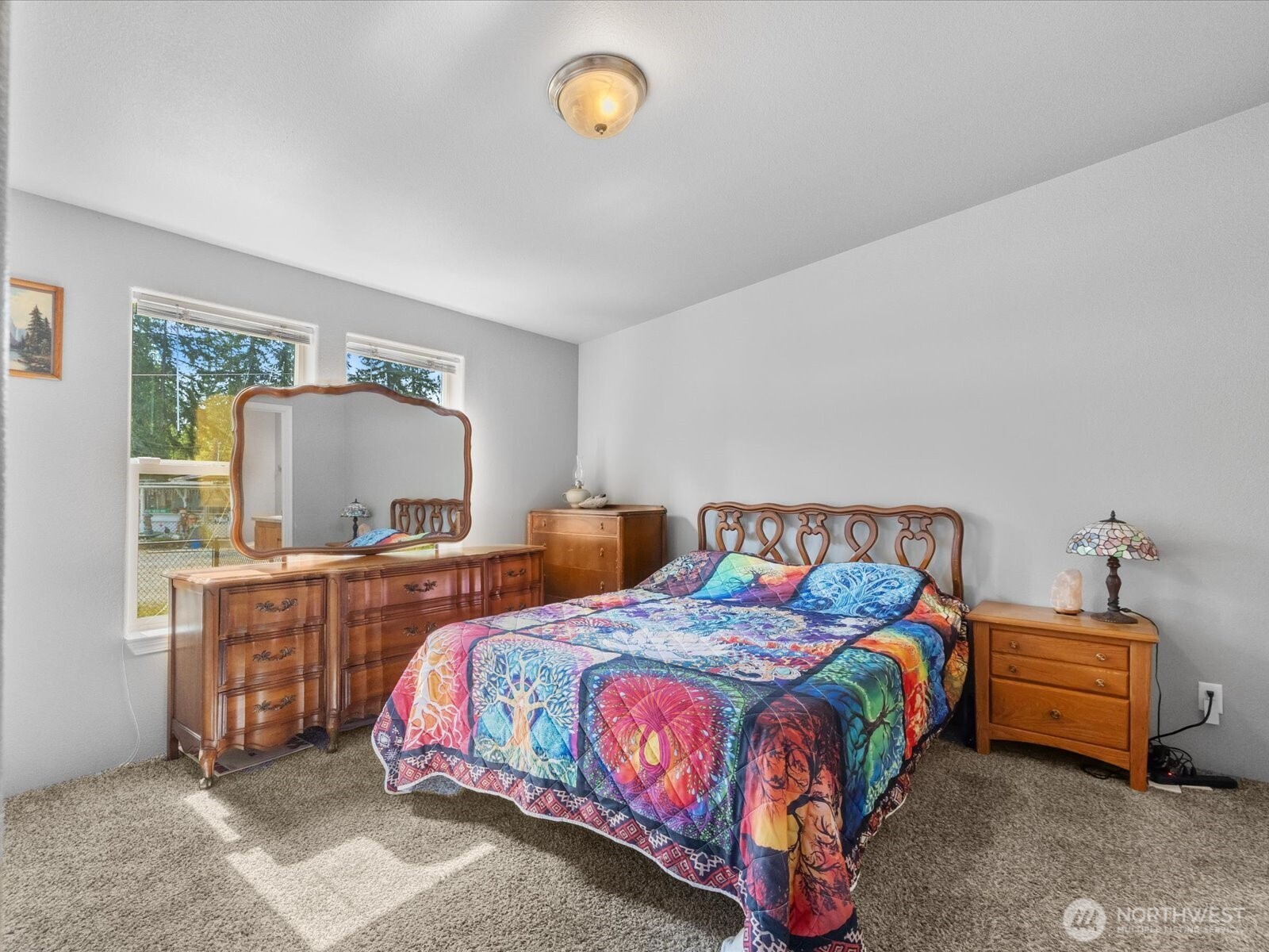 12721 West Macs Loop Road Granite Falls, WA 98252 - Photo 20 of 31 a bedroom with a bed and a chandelier