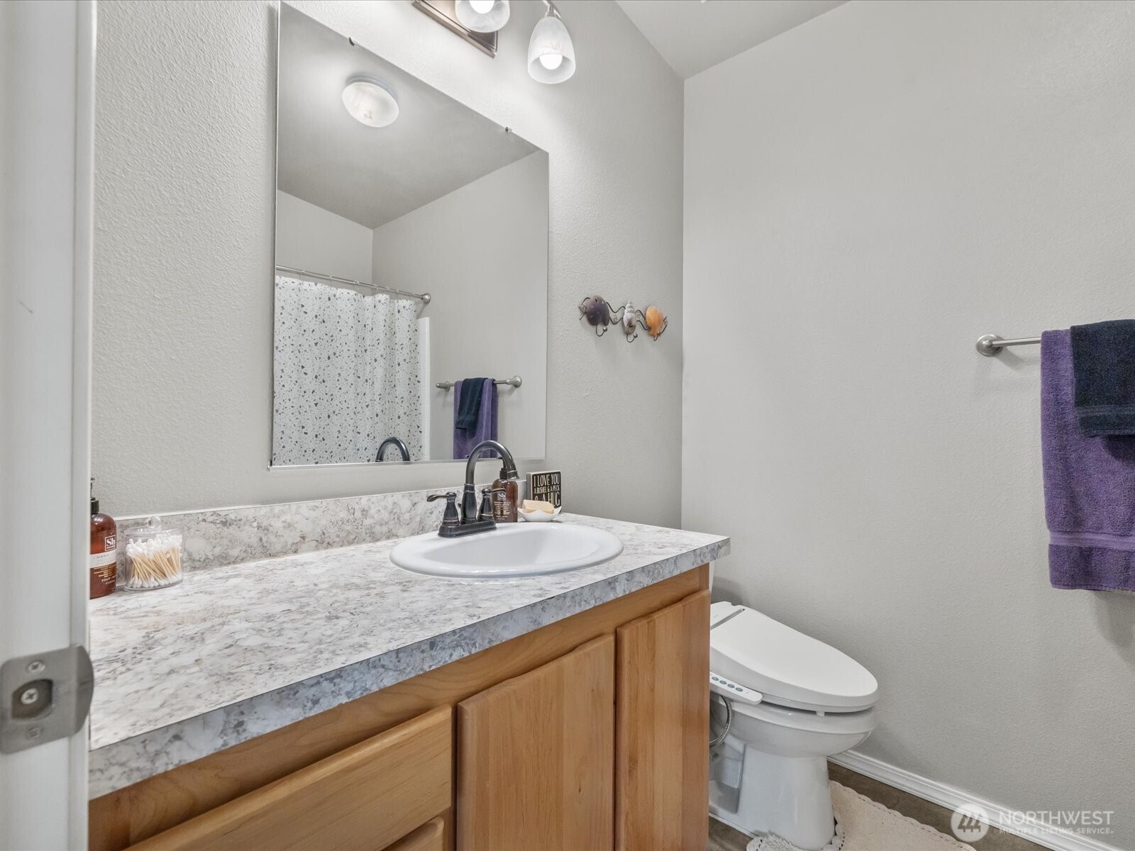 12721 West Macs Loop Road Granite Falls, WA 98252 - Photo 22 of 31 a bathroom with a granite countertop sink a toilet and a mirror