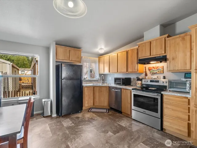 a kitchen with a refrigerator sink and stove