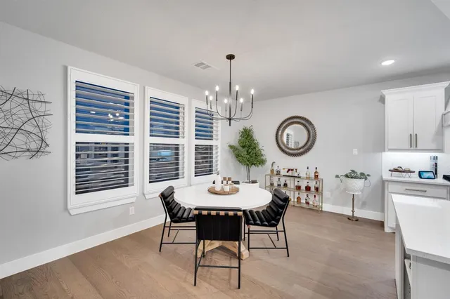 a view of a dining room with furniture and a chandelier