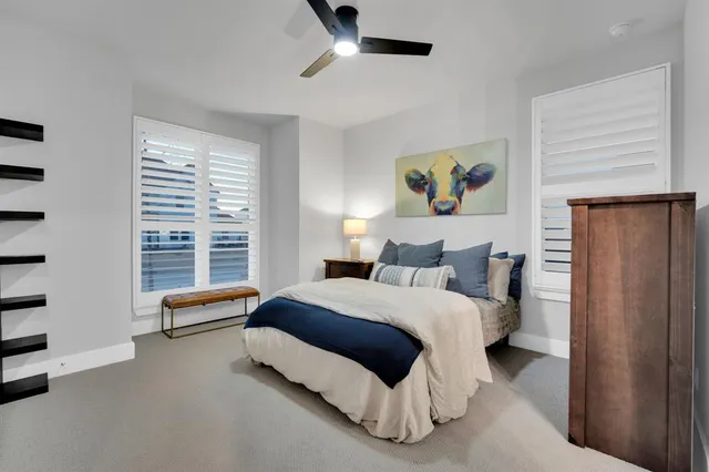 a spacious bedroom with a bed and a window