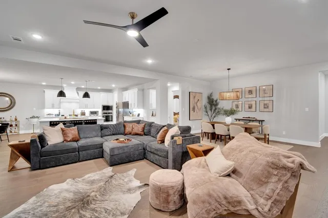 a living room with furniture and a view of kitchen