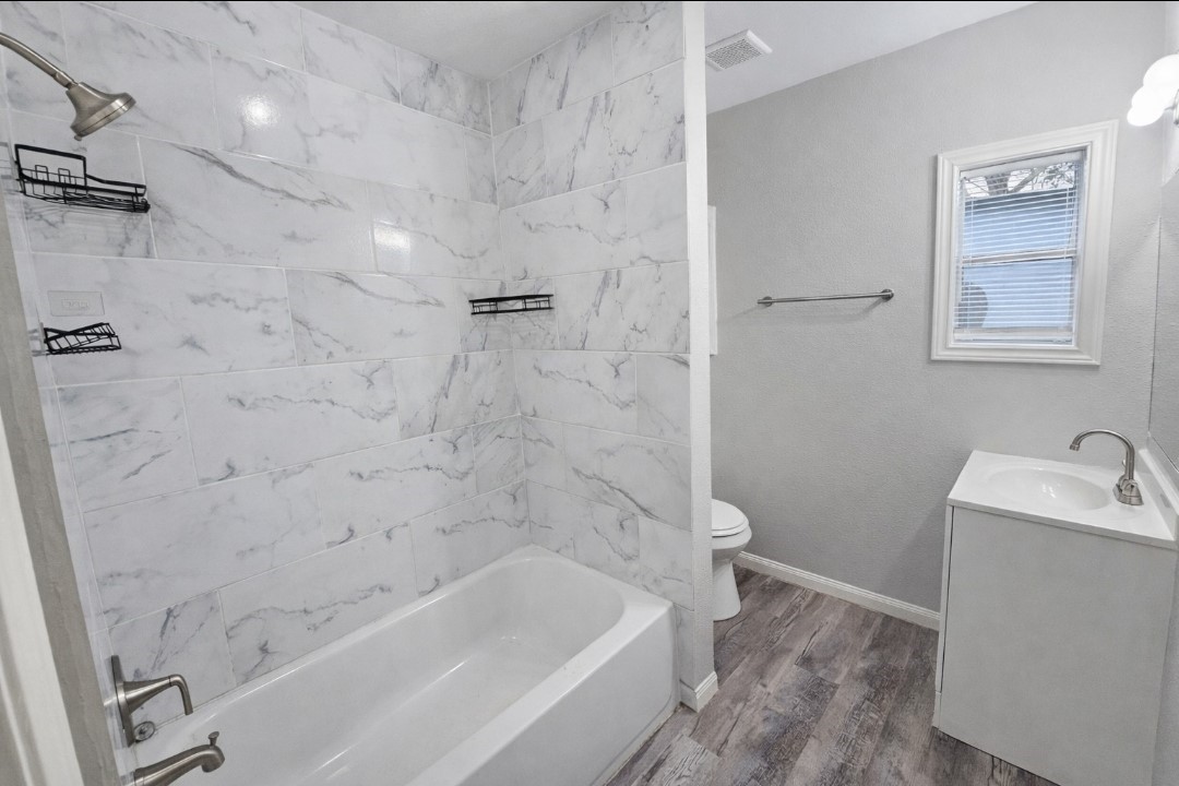 309 E Pine Daisetta, TX 77533 - Photo 12 of 23 a bathroom with a bathtub sink vanity and toilet