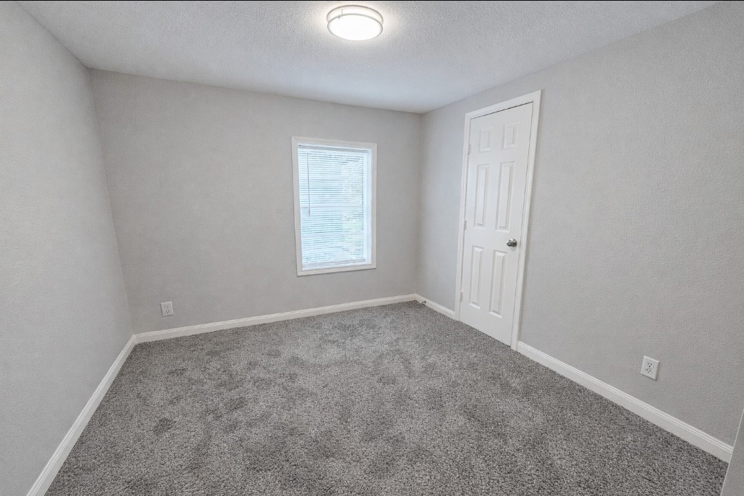 309 E Pine Daisetta, TX 77533 - Photo 14 of 23 an empty room with windows