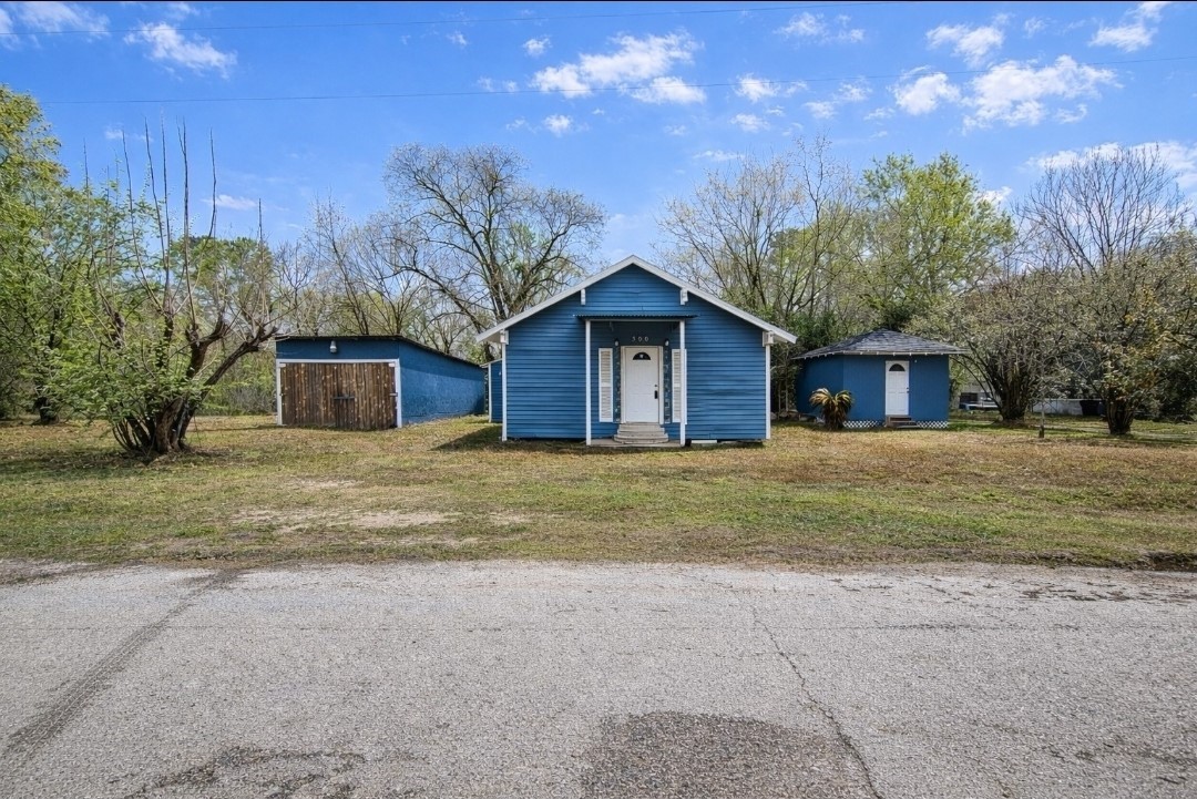 309 E Pine Daisetta, TX 77533 - Photo 2 of 23 a view of a house with a yard and large tree