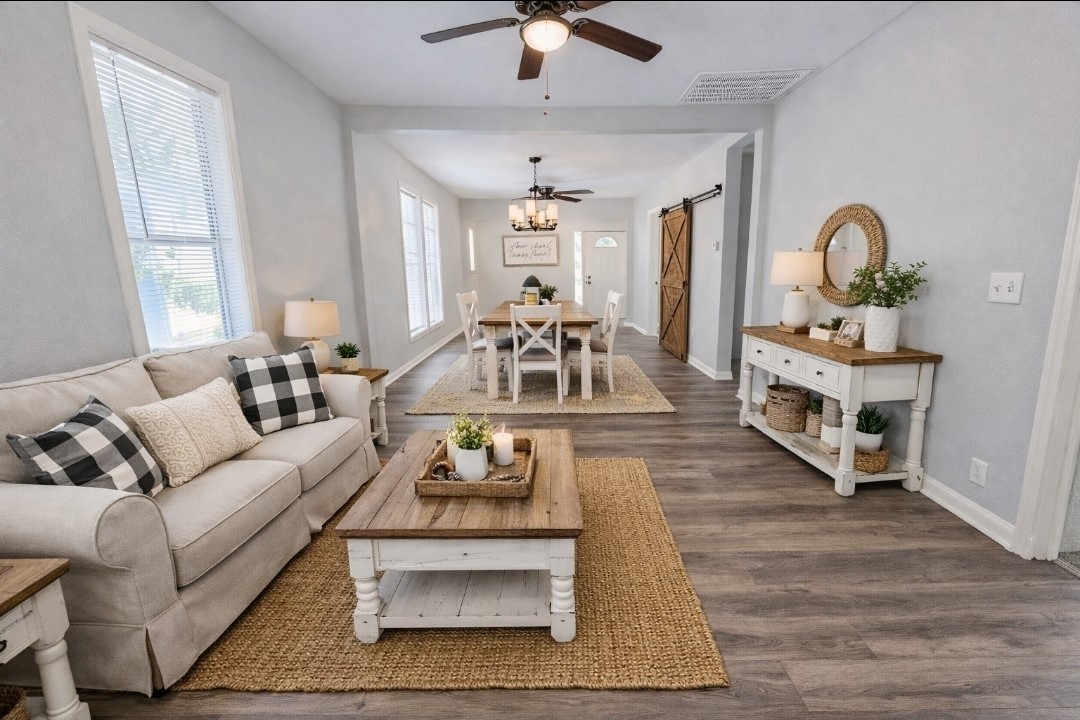 309 E Pine Daisetta, TX 77533 - Photo 3 of 23 a living room with furniture a fireplace and a chandelier