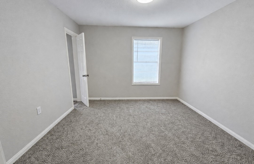 309 E Pine Daisetta, TX 77533 - Photo 8 of 23 an empty room with a window