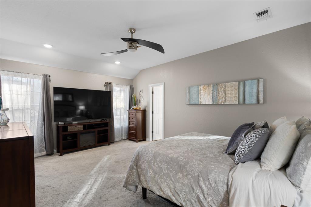 1701 Oakmeadow Drive Decatur, TX 76234 - Photo 16 of 39 a bedroom with a bed and a flat screen tv
