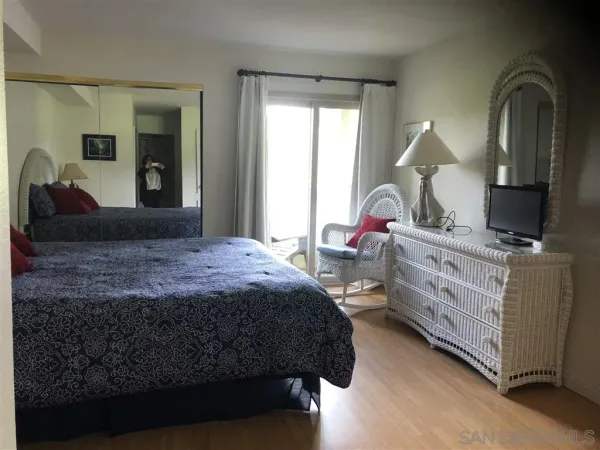 a bedroom with a large bed and a window