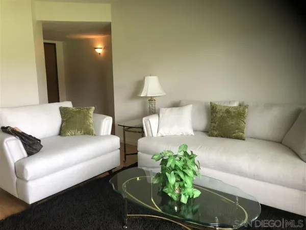 a living room with furniture and a floor to ceiling window