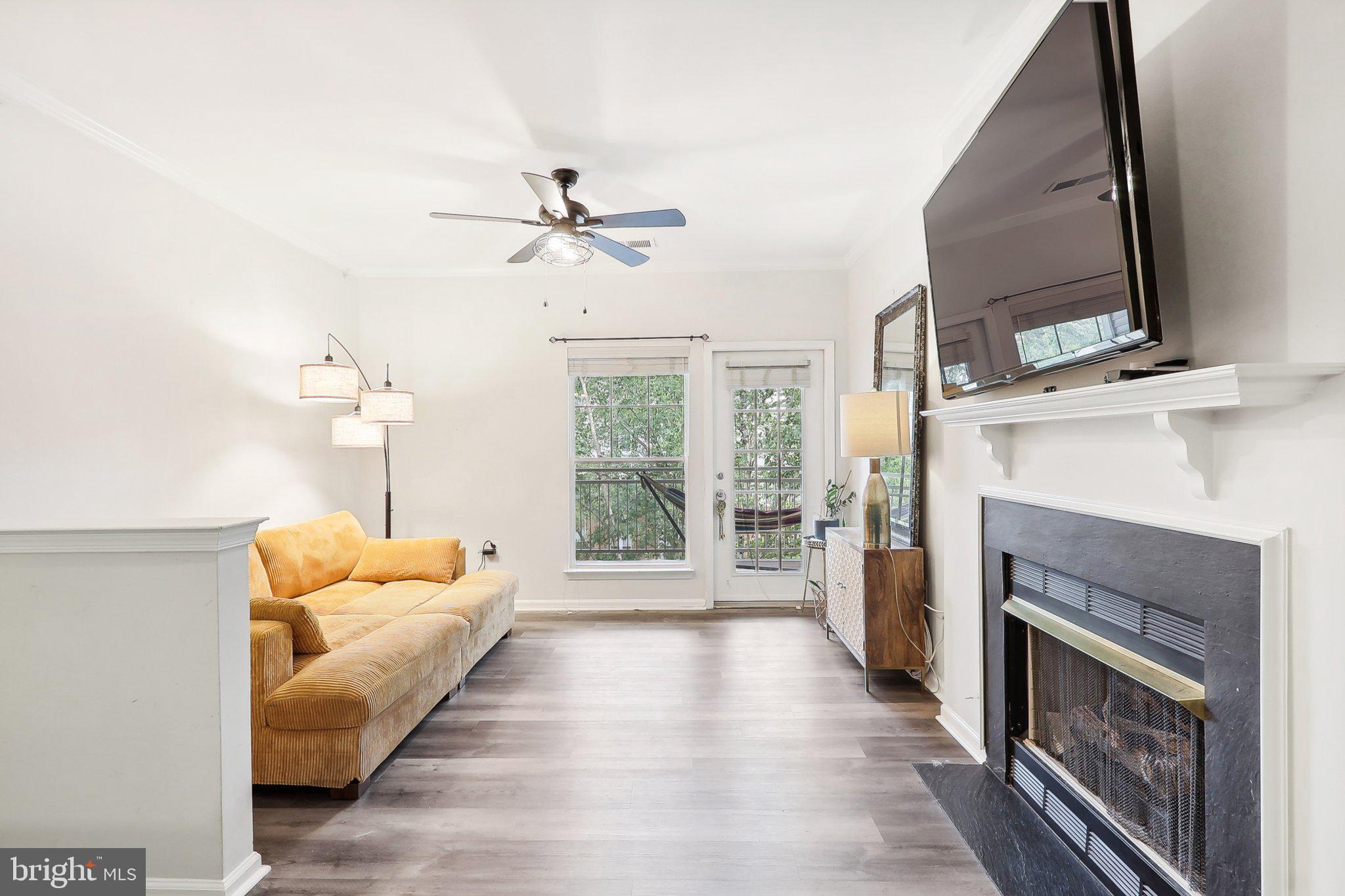 1516 North Point Drive, Unit 301 Reston, VA 20194 - Photo 12 of 31 a living room with furniture fireplace and flat screen tv