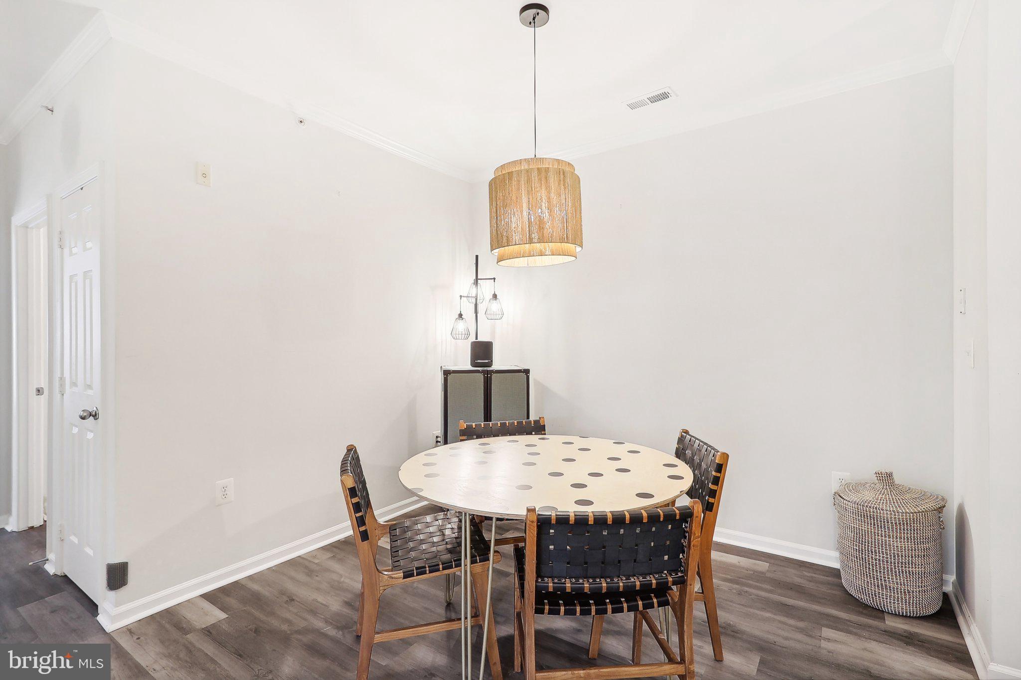 1516 North Point Drive, Unit 301 Reston, VA 20194 - Photo 14 of 31 a view of a dining room with furniture and wooden floor