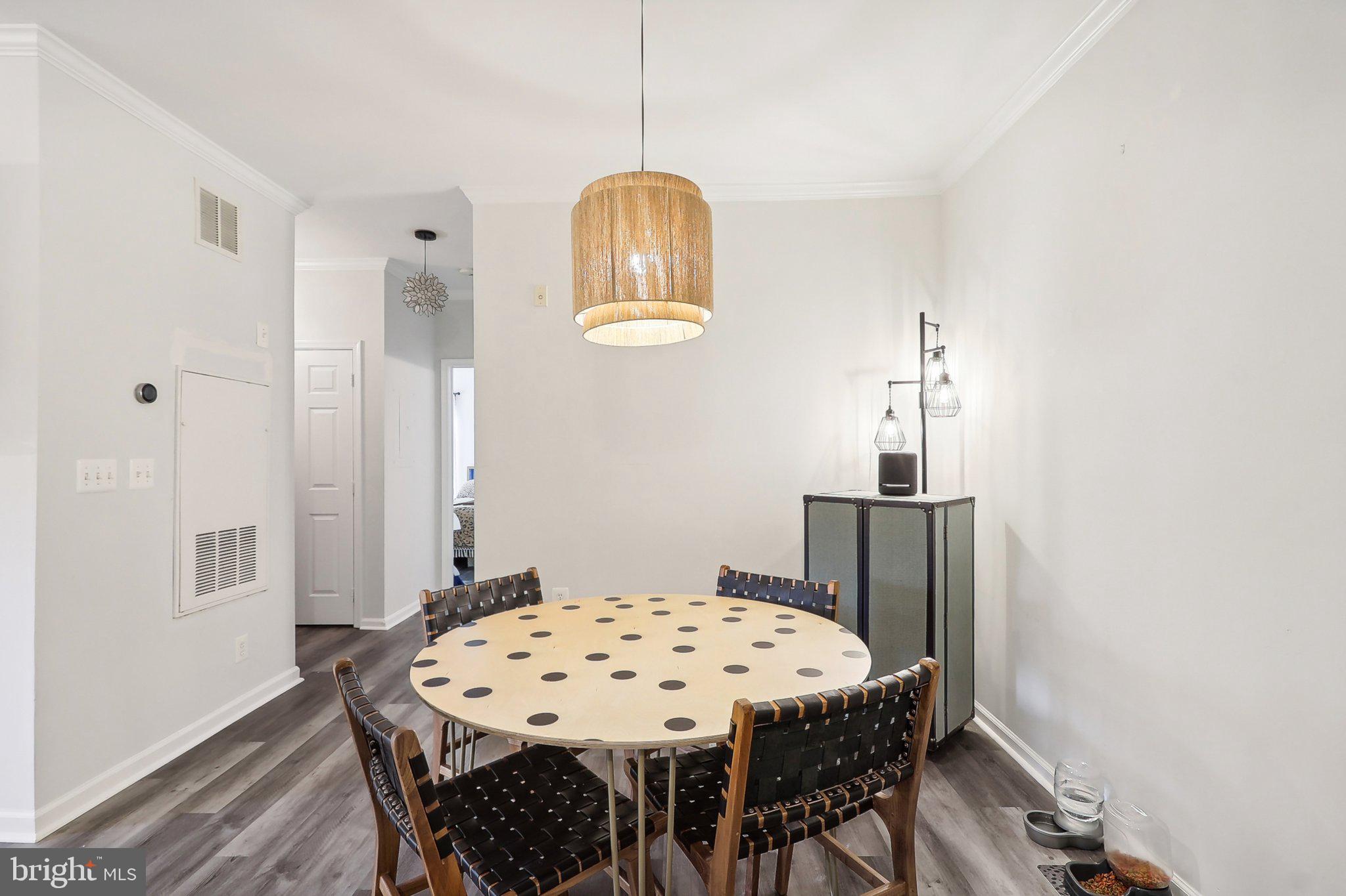 1516 North Point Drive, Unit 301 Reston, VA 20194 - Photo 15 of 31 a view of a dining room with furniture and wooden floor