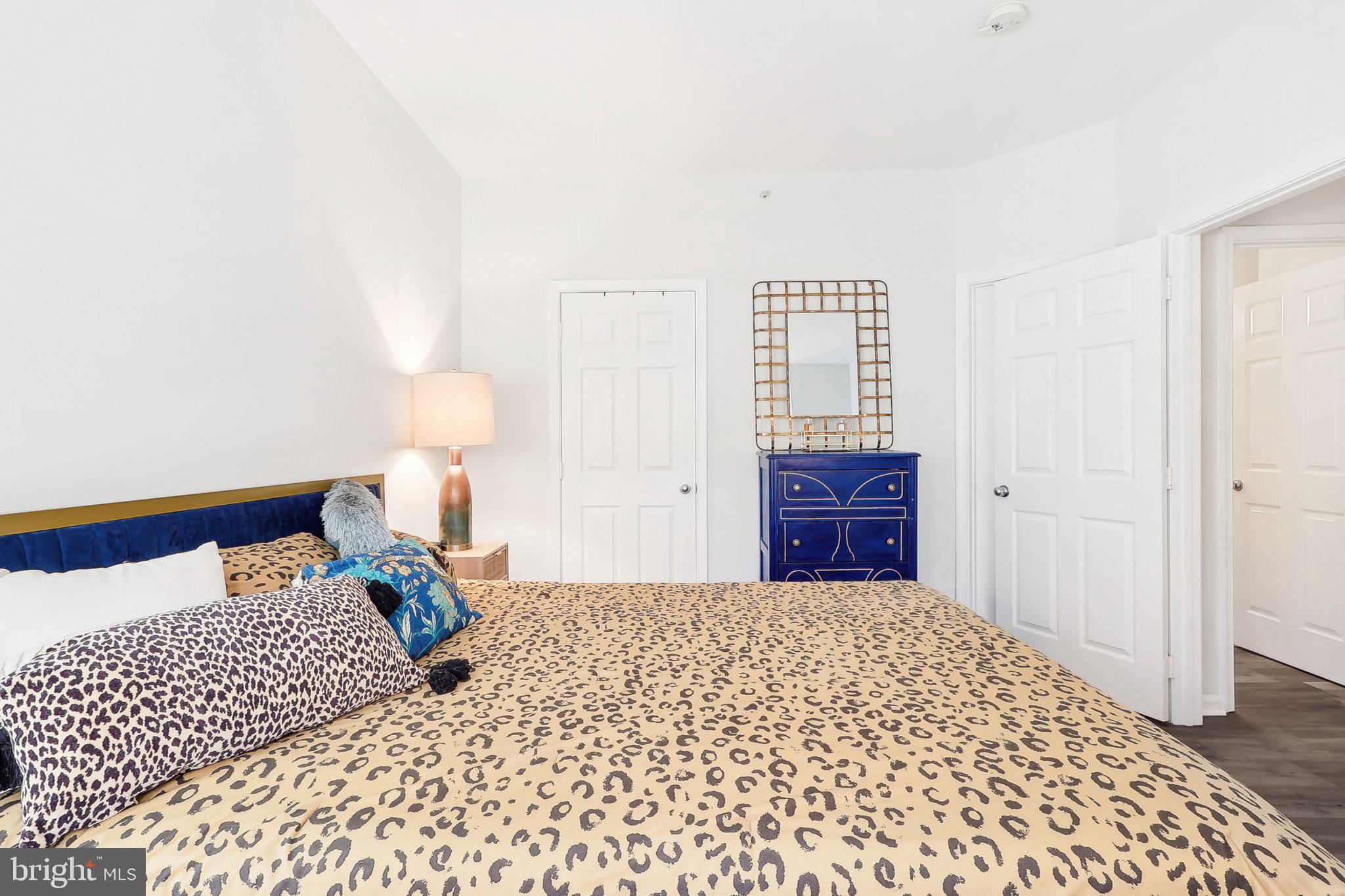 1516 North Point Drive, Unit 301 Reston, VA 20194 - Photo 23 of 31 a bedroom with a bed and a lamp on dresser