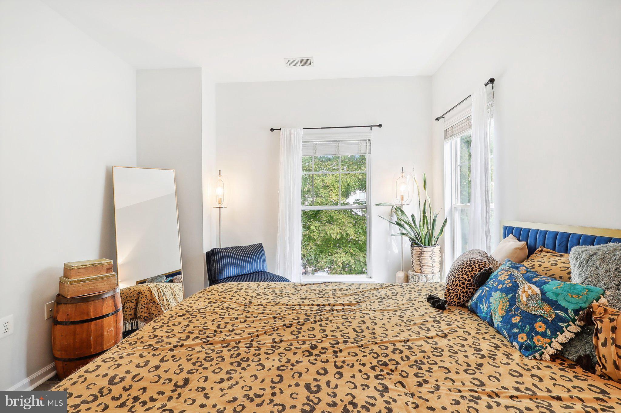 1516 North Point Drive, Unit 301 Reston, VA 20194 - Photo 24 of 31 a bedroom with a bed and a large window