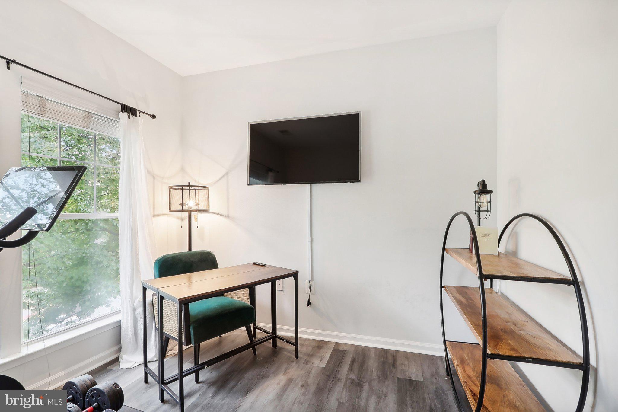 1516 North Point Drive, Unit 301 Reston, VA 20194 - Photo 25 of 31 a living room with furniture and a flat screen tv