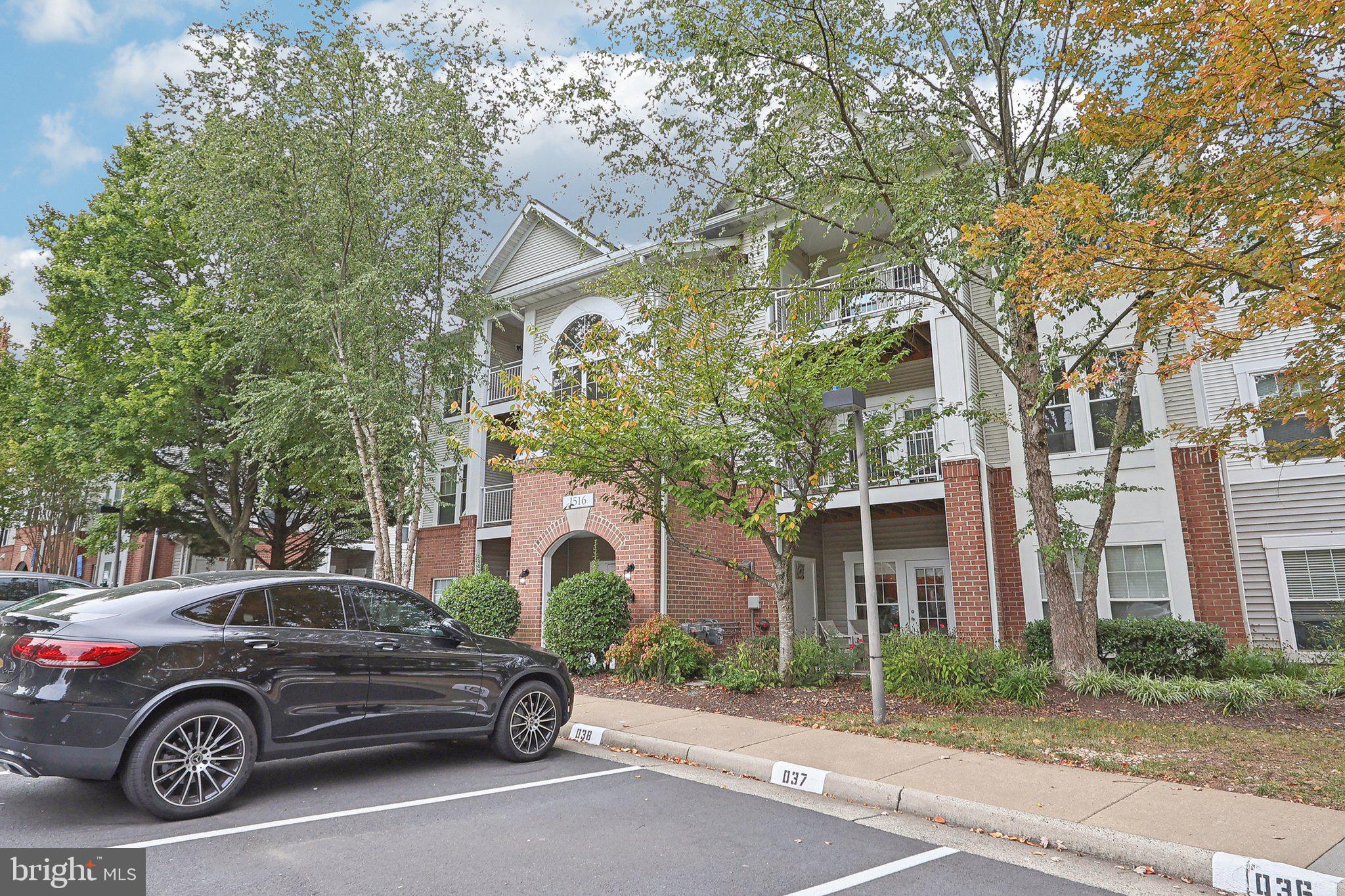 1516 North Point Drive, Unit 301 Reston, VA 20194 - Photo 4 of 31 a car parked in front of a brick house