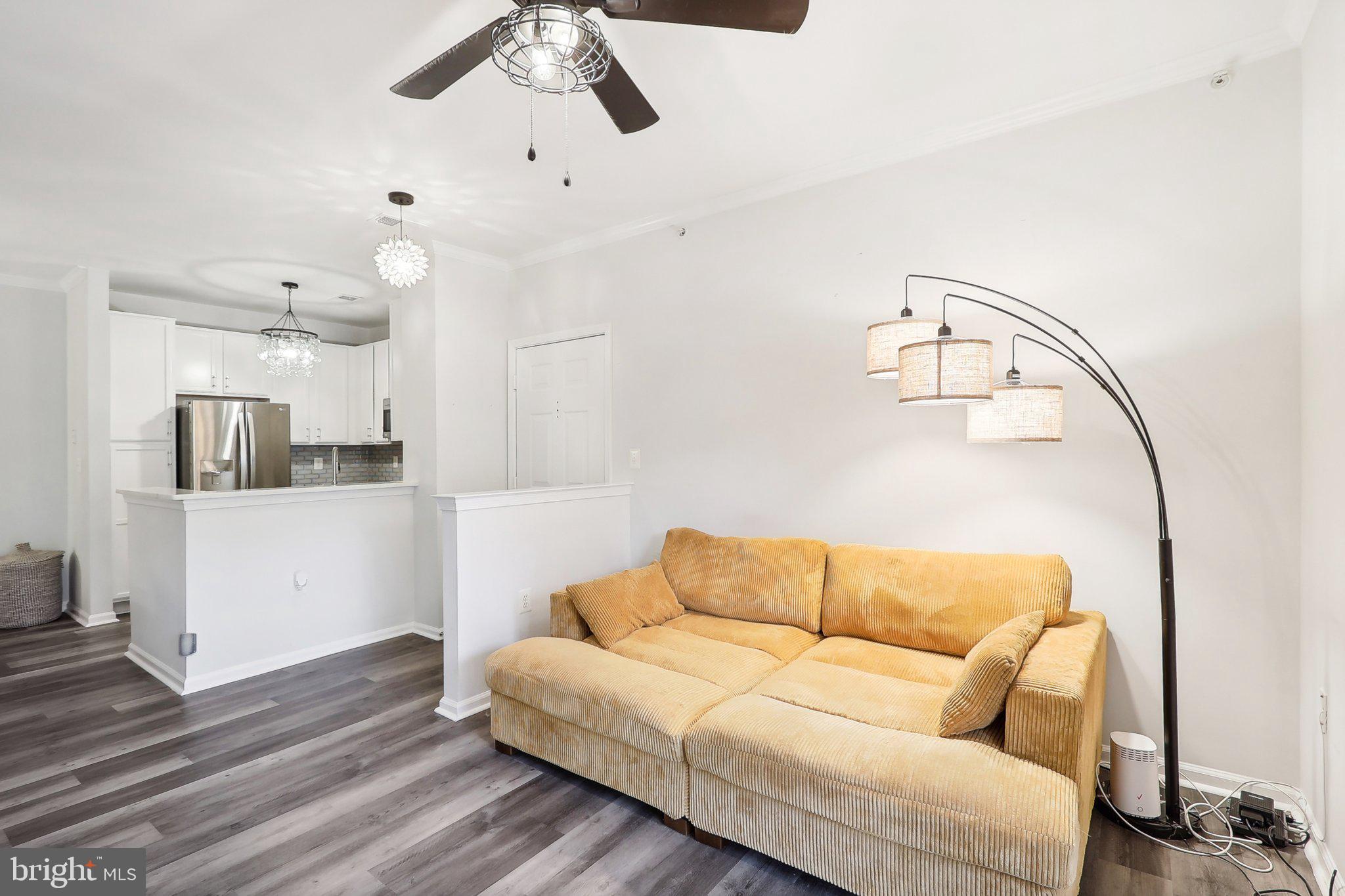 1516 North Point Drive, Unit 301 Reston, VA 20194 - Photo 9 of 31 a living room with furniture and kitchen view