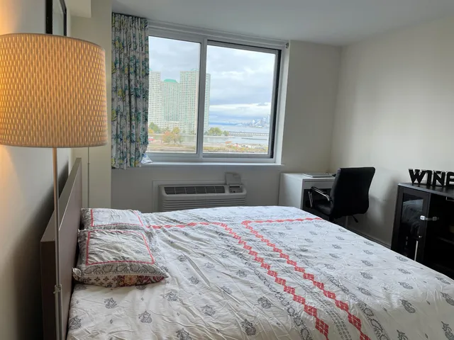 a bedroom with a bed and a window