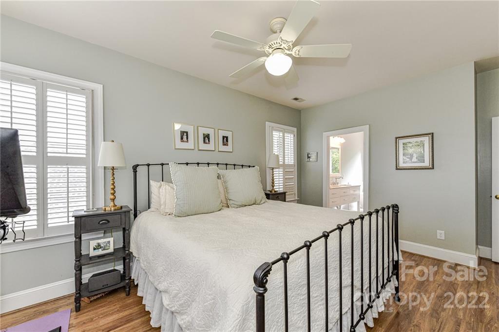 113 Morrison Hill Road Davidson, NC 28036 - Photo 14 of 27 a bedroom with a bed and a chandelier