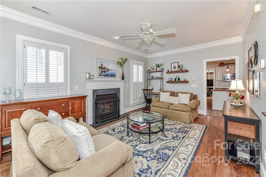 113 Morrison Hill Road Davidson, NC 28036 - Photo 3 of 27 a living room with furniture a fireplace and a flat screen tv