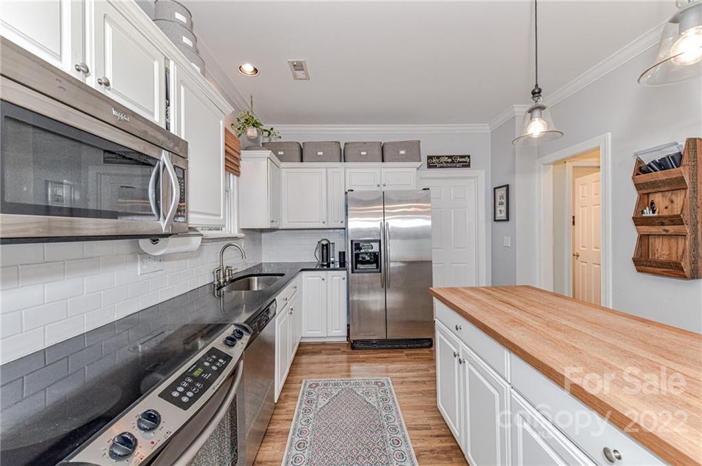 113 Morrison Hill Road Davidson, NC 28036 - Photo 8 of 27 a kitchen with a refrigerator and a stove top oven