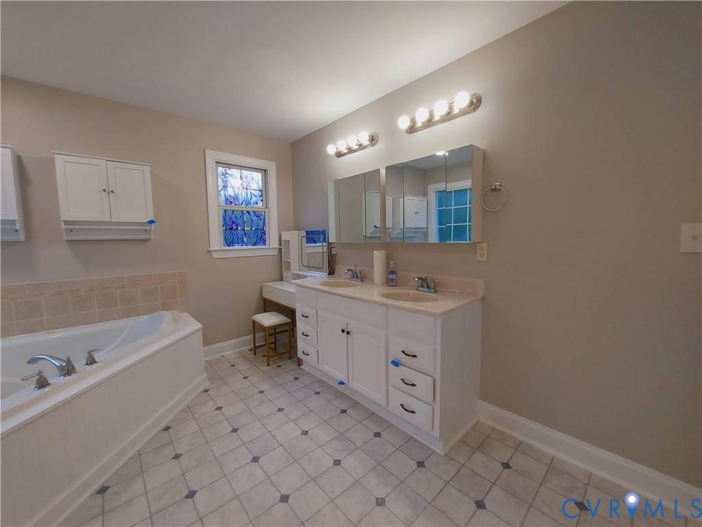 18313 Shiloh Church Road Beaverdam, VA 23015 - Photo 15 of 39 a bathroom with a sink mirror and a bathtub