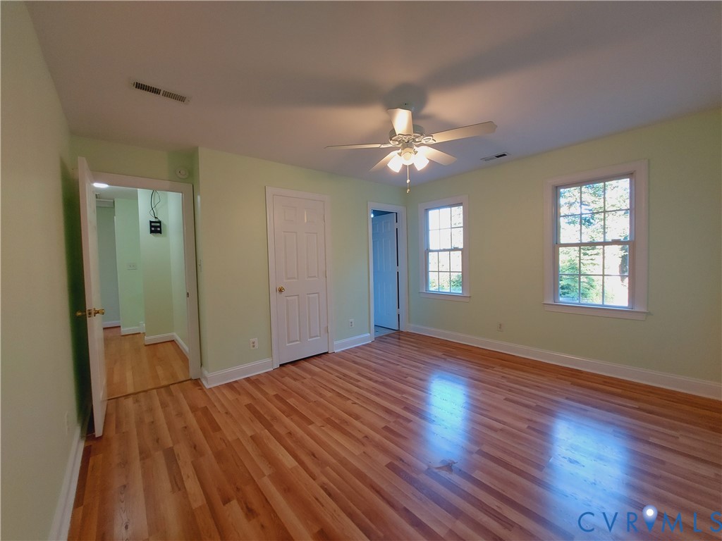 18313 Shiloh Church Road Beaverdam, VA 23015 - Photo 31 of 39 an empty room with wooden floor and windows