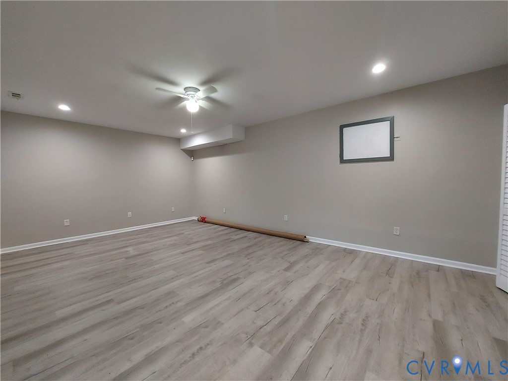 18313 Shiloh Church Road Beaverdam, VA 23015 - Photo 35 of 39 an empty room with wooden floor and a ceiling fan