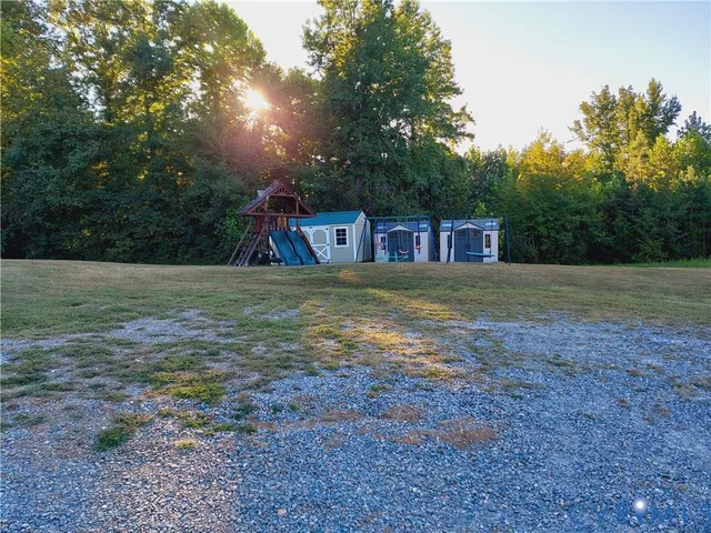 a view of outdoor space with playground and green space
