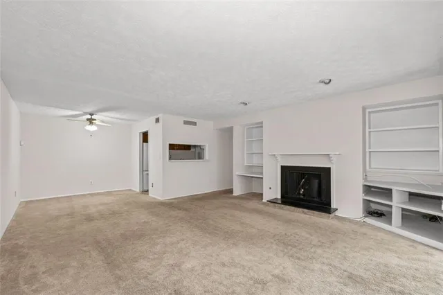 a view of empty room with a fireplace