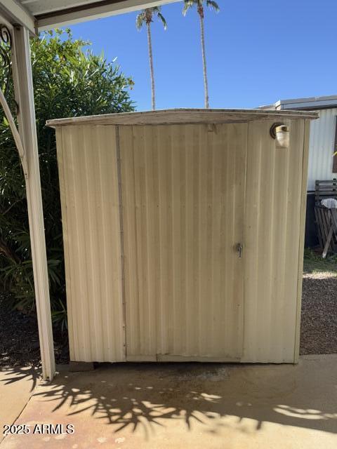 9501 East Broadway Road, Unit 119 Mesa, AZ 85208 - Photo 19 of 24 a view of a car garage with a wooden fence