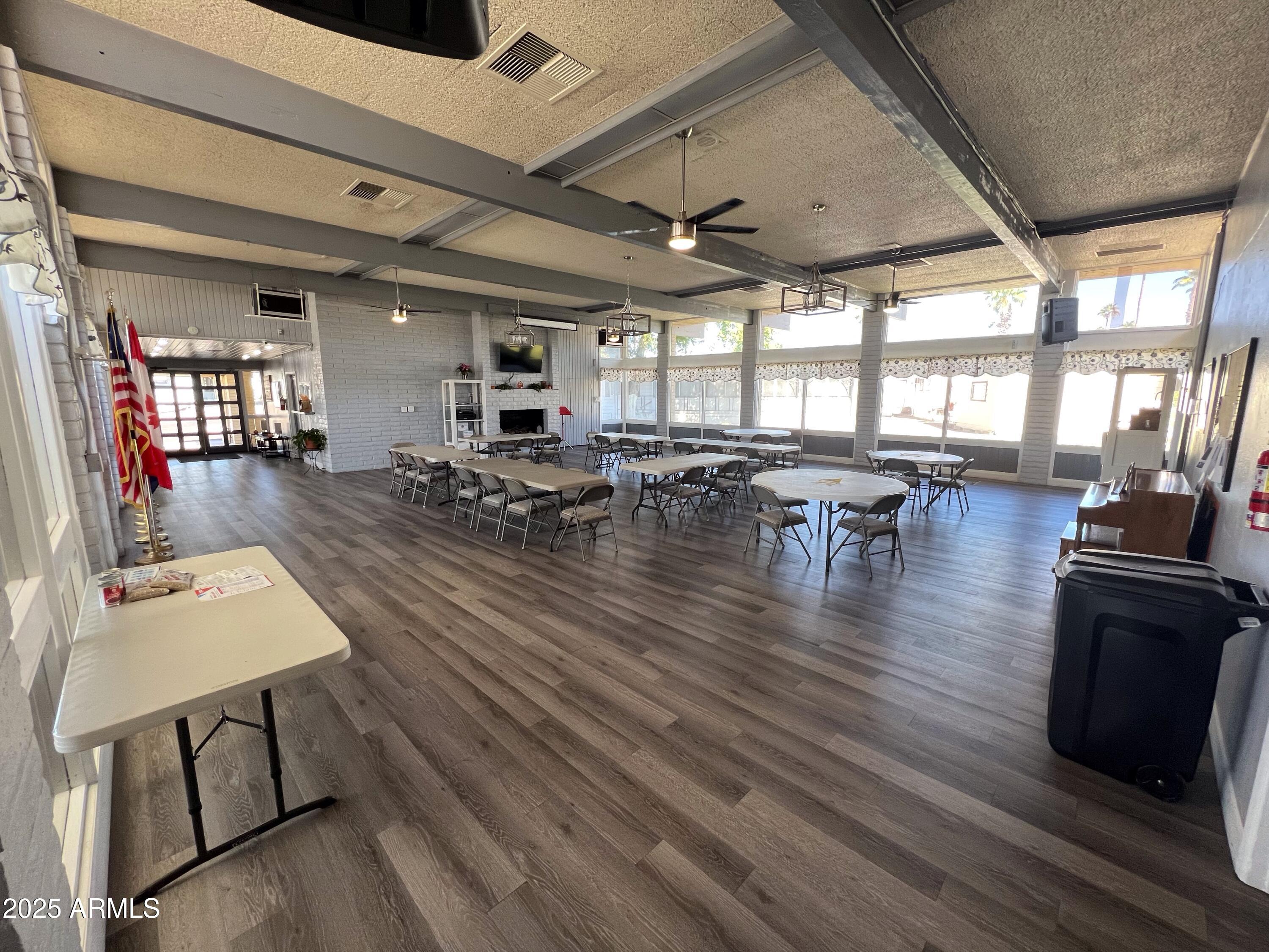 9501 East Broadway Road, Unit 119 Mesa, AZ 85208 - Photo 22 of 24 a living room with lots of furniture wooden floor and large windows