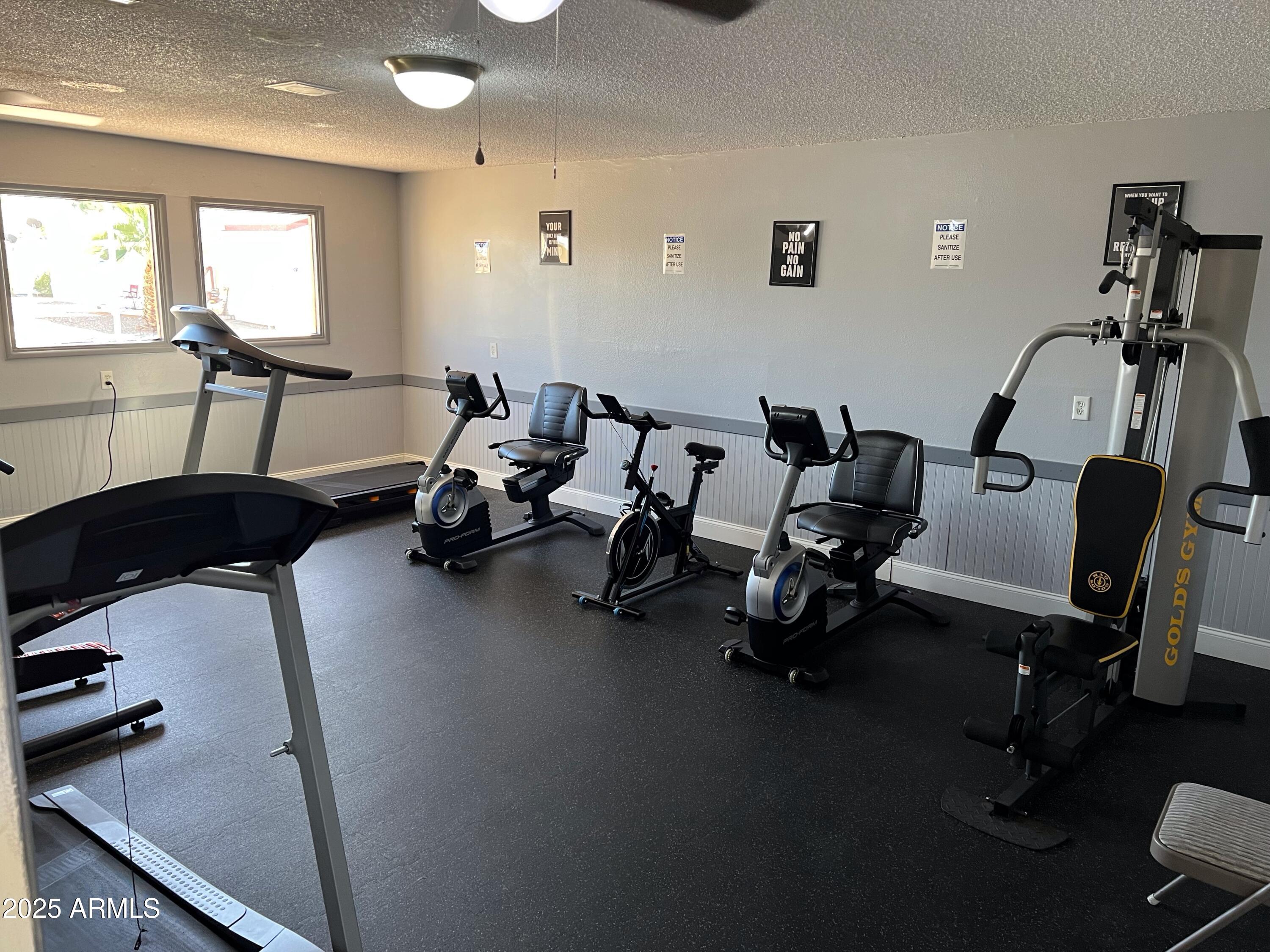 9501 East Broadway Road, Unit 119 Mesa, AZ 85208 - Photo 23 of 24 a room with gym equipment and a table