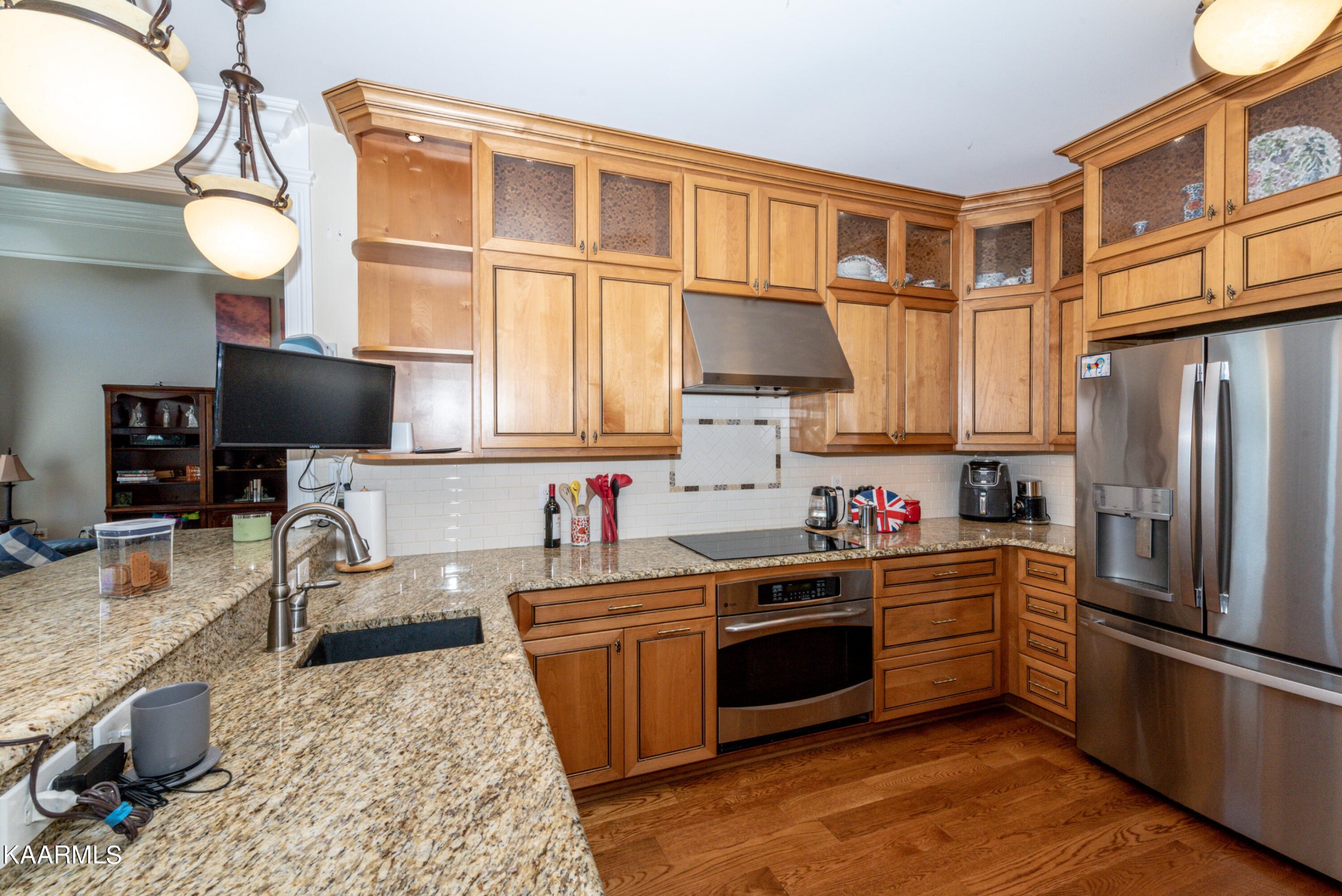 6069 Morganton Road Greenback, TN 37742 - Photo 26 of 60 a kitchen with stainless steel appliances granite countertop a stove top oven a sink dishwasher and a microwave with wooden cabinets