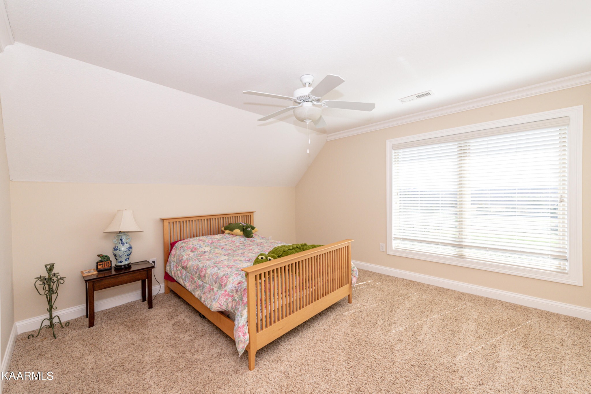 6069 Morganton Road Greenback, TN 37742 - Photo 58 of 60 a bedroom with a bed and a chandelier fan