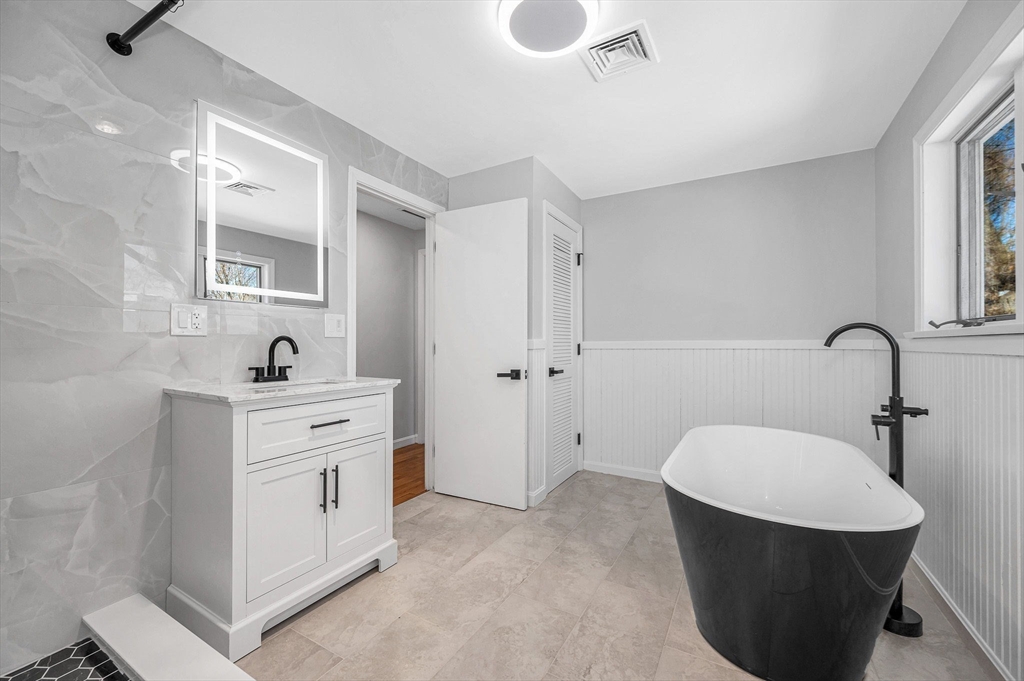 52 Elm Street Haverhill, MA 01830 - Photo 19 of 40 a bathroom with a sink a toilet and shower