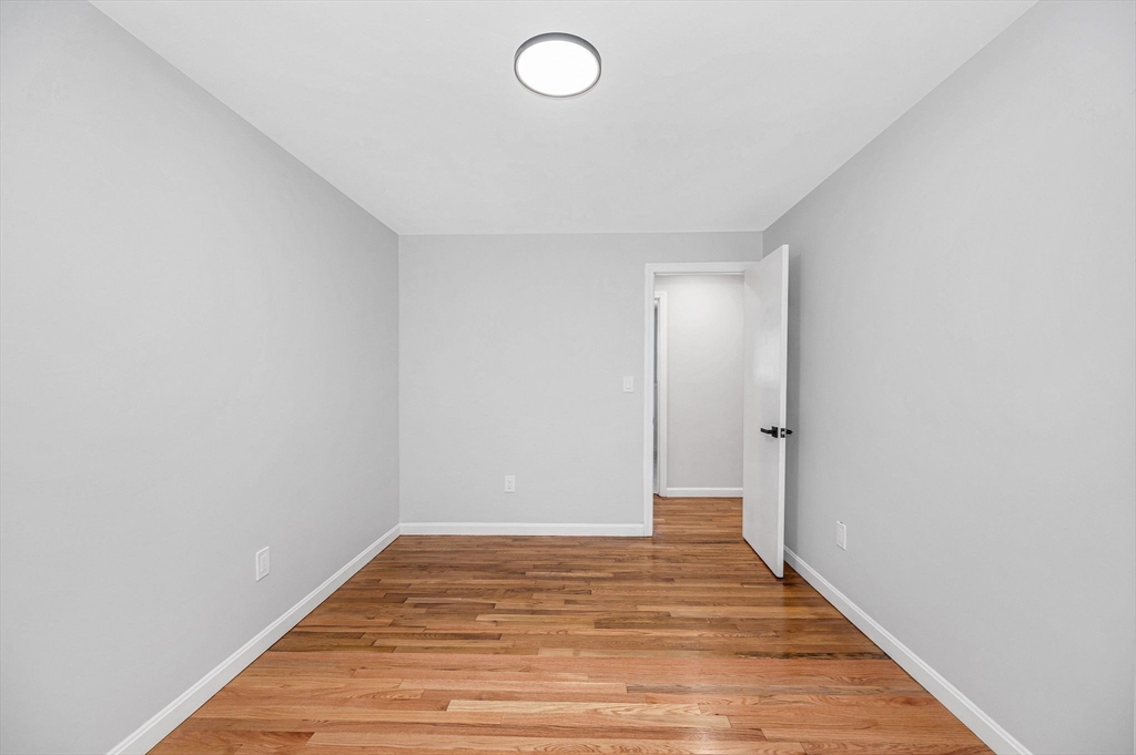 52 Elm Street Haverhill, MA 01830 - Photo 22 of 40 a view of a room with wooden floor and white walls